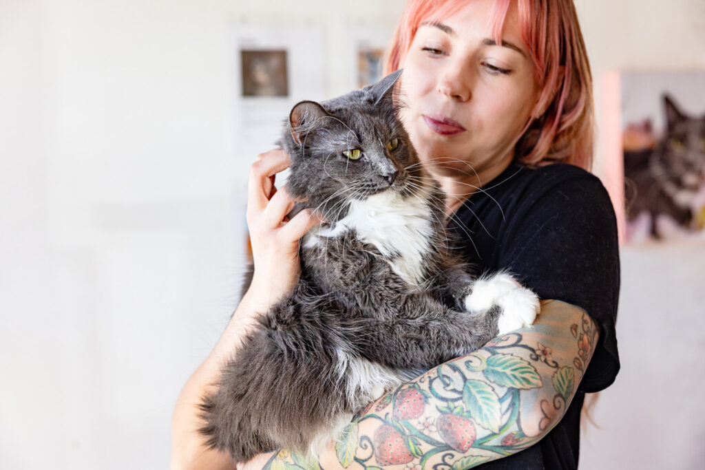 Mary Costello cuddles Syd, the resident domestic long hair at Espurresso.