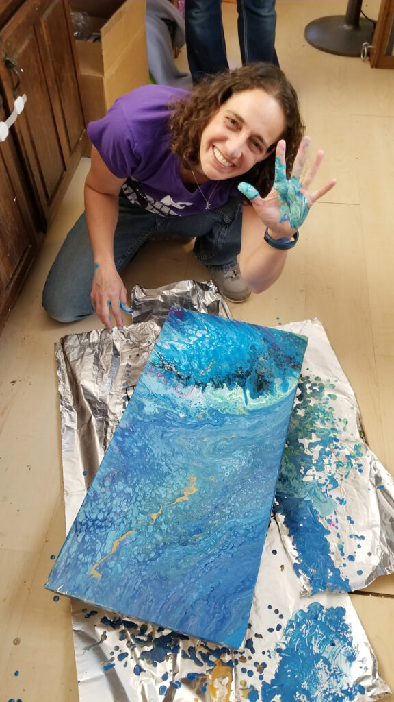 Picture of Tammy Karin working on pour painting