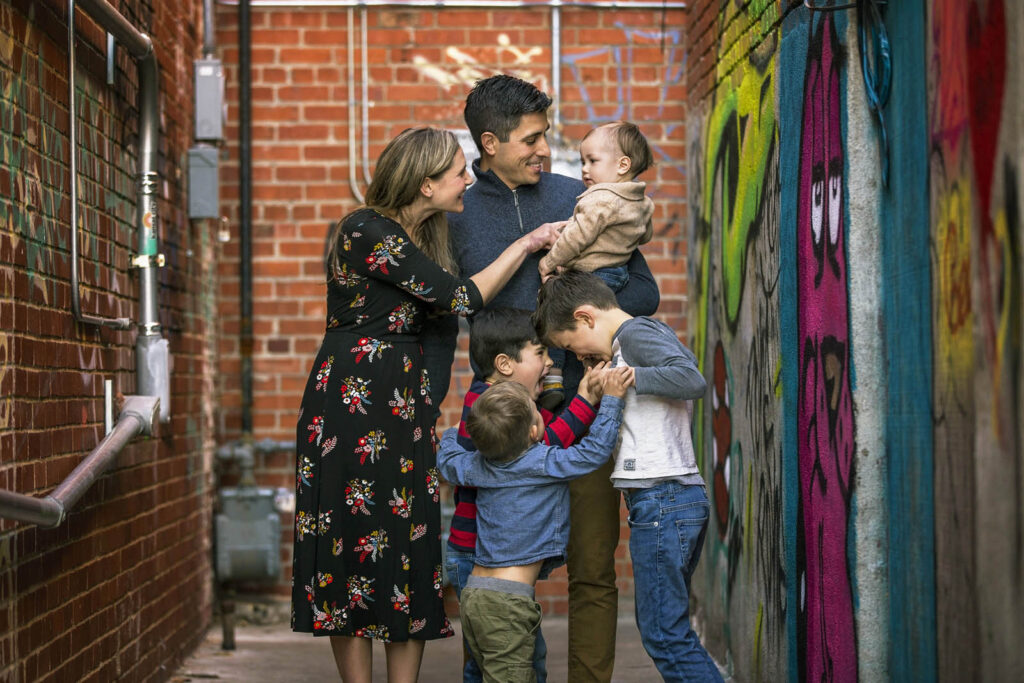 A fun, unscripted family moment captured in the vibrant alleyways of Aggieville.