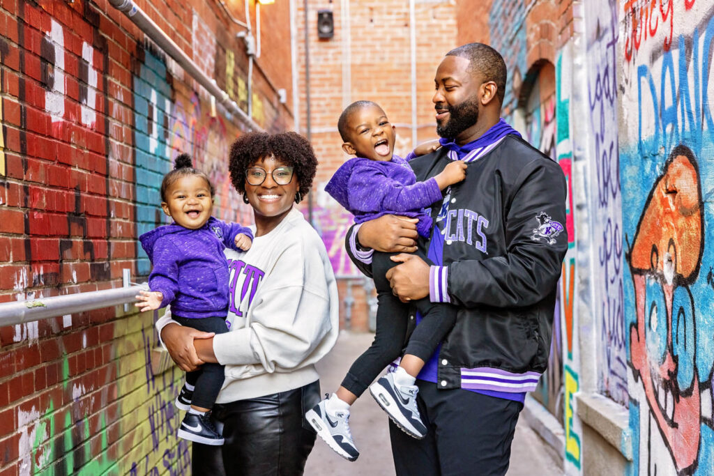 Fun family photos in a colorful alleyway in Aggieville.