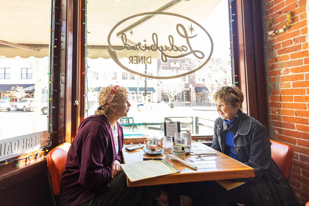 Owner Meg Heriford of Ladybird Diner eating pie with her mother in Lawrence.